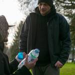 Jonathan Centeno-Echavarria (left) speaks about his experience living in his car to Aaron King, a community resource navigator, Feb. 22 in Everett. Centeno-Echavarria left a bad situation in Seattle and was looking for a more permanent living situation. (Ryan Berry / The Herald)