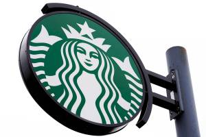 FILE - A sign at a Starbucks location in Havertown, Pa., is seen April 26, 2022. Starbucks says it will pay travel expenses for U.S. employees to access abortion or gender-confirmation procedures if those services aren't available within 100 miles of a worker’s home. The Seattle coffee chain says, Monday, May 16, 2022, the benefit will also be available to dependents of employees enrolled in its health care coverage. (AP Photo/Matt Rourke, file)