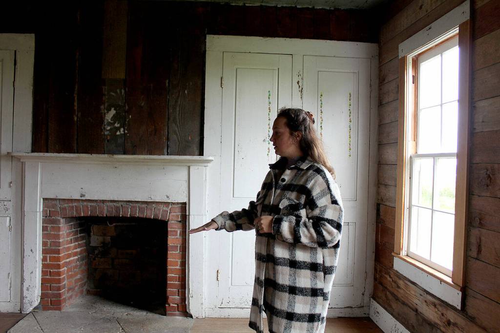 Reserve education and outreach coordinator Jordan Belcher shows the former dining room of the Jacob and Sarah Ebey House. (Karina Andrew / Whidbey News-Times)