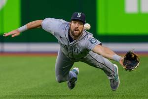 Seattle Mariners right fielder Steven Souza Jr. dives to try to catch a ball hit by Toronto Blue Jays' George Springer for a three-run triple during the second inning of a baseball game Tuesday, May 17, 2022, in Toronto. (Frank Gunn/The Canadian Press via AP)
