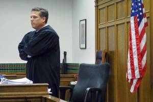 King County Superior Court Judge Roger  Rogoff stands in court, Monday, Oct. 10, 2016, in Seattle. Rogoff announced Monday that a settlement had been reached in a lawsuit brought by survivors and family members of people killed in a 2014 Oso, Wash., landslide against the state of Washington and a timber company that logged an area above the site of the slide. (AP Photo/Ted S. Warren)