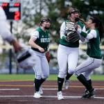 Skyline senior pitcher Ryan Grace is swarmed by teammates after striking out her 24th and final batter in the Spartans 3-2 10-inning win over Jackson in a Class 4A District 1/2 Tournament semifinal Wednesday at Phil Johnson Ballfields. (Ryan Berry / The Herald)