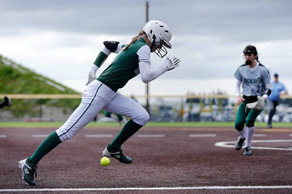 Skylines Macen Staley beats out a bunt against Jackson during Wednesdays Class 4A matchup at the Phil Johnson Ballfields in Everett. (Ryan Berry / The Herald)