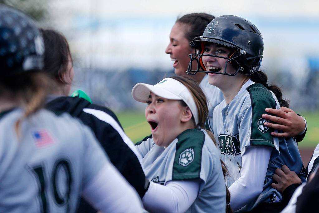 Jacksons Allie Thomsen celebrates a two-run home run with her teammates during Wednesdays Class 4A matchup at the Phil Johnson Ballfields in Everett. (Ryan Berry / The Herald)
