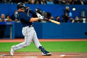 Seattle Mariners' Ty France hits a single during the first inning of a baseball game against the Toronto Blue Jays in Toronto on Wednesday, May 18, 2022. (Jon Blacker/The Canadian Press via AP)