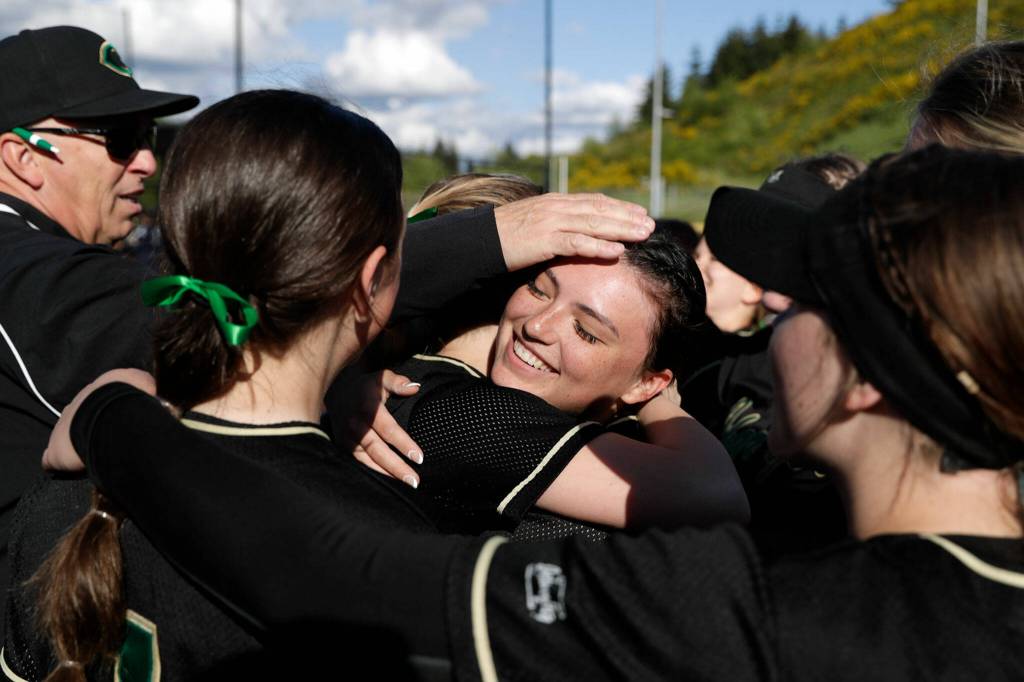 Marysville Getchell senior pitcher Morgan Epperson is congratulated by teammates after a strong complete-game performance in the circle. (Kevin Clark / The Herald)