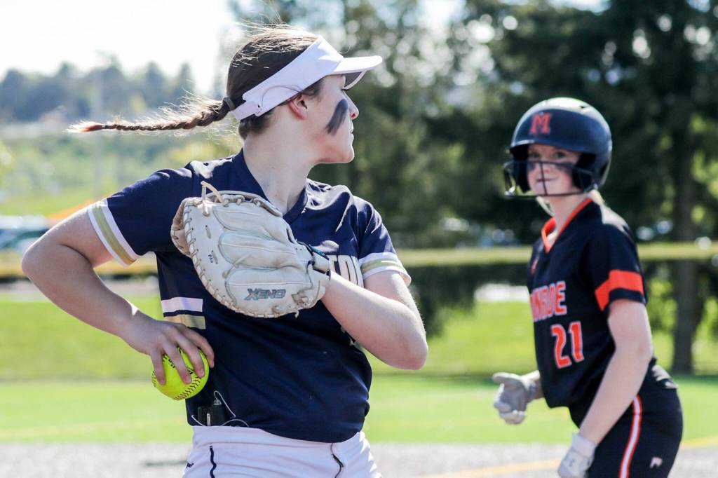 Arlingtons Tayler Stevens looks to Monroes Scarlett Nagy after a pop up catch at Phil Johnson Ball Field in Everett, Washington on May 19, 2022.(Kevin Clark / The Herald)