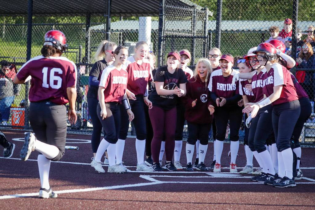 Cascade welcomes Jaidyn Wilson home after her two-run homer against Snohomish Thursday evening at Phil Johnson Ball Field in Everett, Washington on May 19, 2022. The Bruins defeated the Panthers 14-7 to claim the NW District 1 3A Championship title. (Kevin Clark / The Herald)
