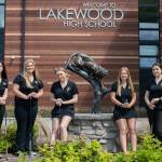 Lakewood High School golfers, from left, Haley Callan, Kiana Schroeder, Malia Schroeder, Mandy Harrison and Audree Jordan, stand in front of their school Thursday, in Arlington. The Schroeder sisters qualified for state, and Callan was named as an alternate. (Ryan Berry / The Herald)