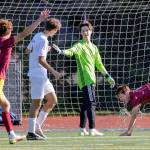 Reactions to Lakesides Cole Browns goal, far right, against Edmonds-Woodway Friday afternoon in Seattle, Washington on May 20, 2022. The Warriors lost 4-0. (Kevin Clark / The Herald)