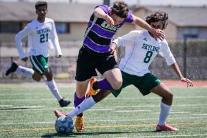 Kamiak’s Koll Pehlivanian’s charge is halted by Skyline’s Vishnu Varadhan Saturday afternoon at Goddard Stadium in Everett, Washington on May 21, 2022. The Knights lost 5-2. (Kevin Clark / The Herald)