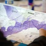 Ken Crossman, from Snohomish County Planning and Development, looks over a flood map of the Skykomish during a disaster simulation Wednesday in Sultan. (Ryan Berry / The Herald)