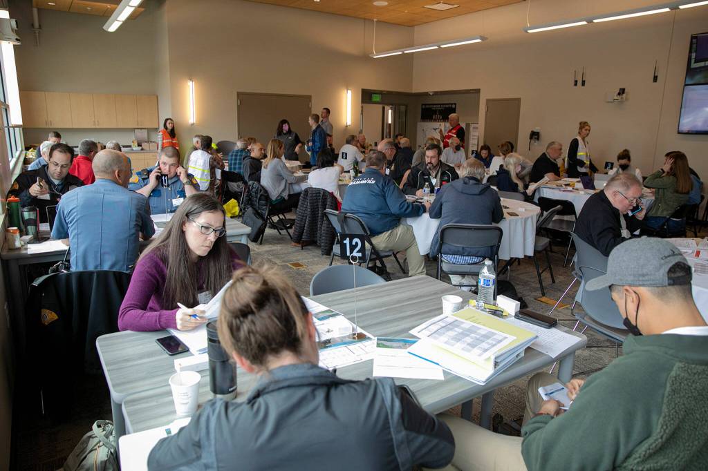Dozens of workers from around the county are split into groups Wednesday as they work to navigate a simulated situation in which the Culmback Dam fails. (Ryan Berry / The Herald)