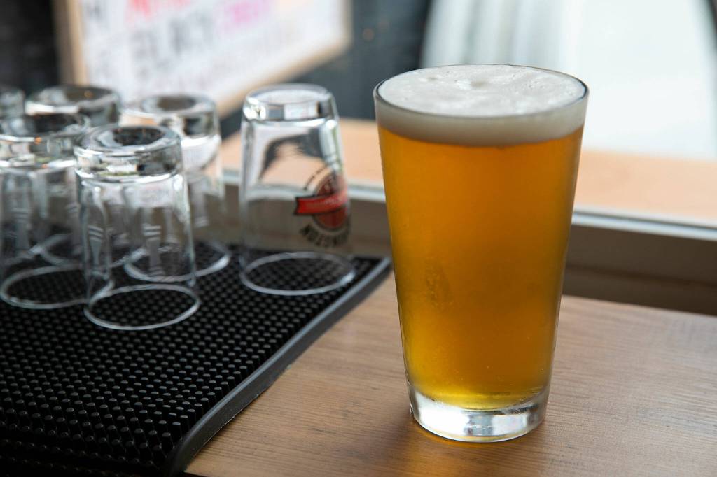 A freshly poured blonde ale sits in the window at Thirsty Crab Brewery. (Ryan Berry / The Herald)
