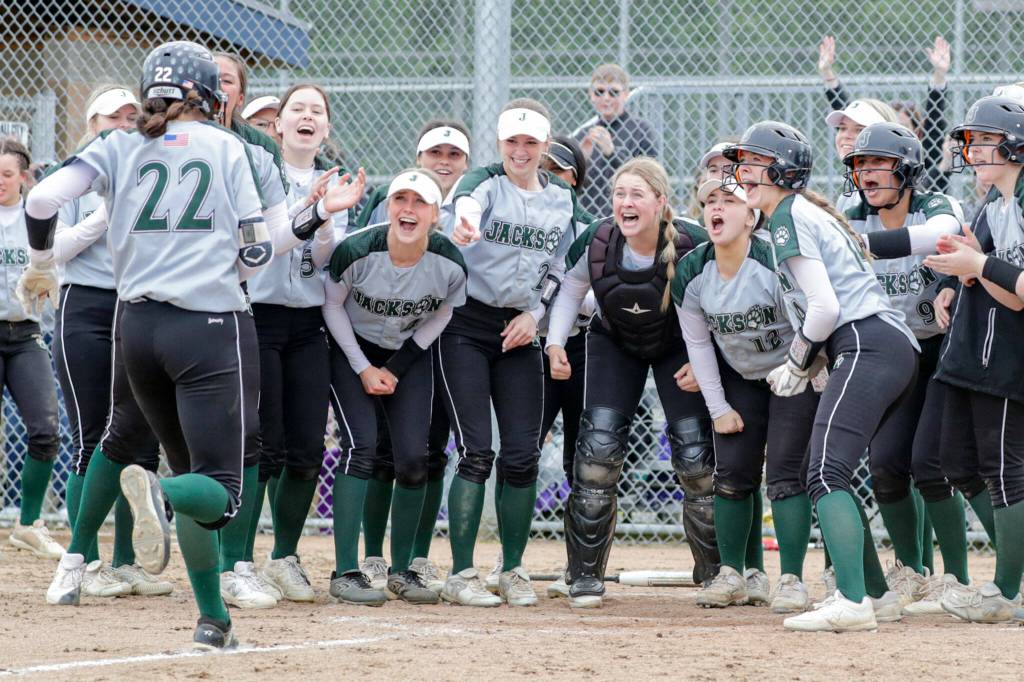 Jackson’s Allie Thomsen is greeted at home for the two run game tying homer against Glacier Peak Wednesday afternoon at Glacier Peak High School in Snohomish, Washington on May 11, 2022. The Timberwolves defeated the Grizzles 5-3 in extra innings to claim the league title. (Kevin Clark / The Herald)