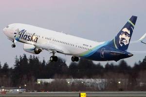 FILE - In this Monday, March 1, 2021 file photo, The first Alaska Airlines passenger flight on a Boeing 737-9 Max airplane takes off on a flight to San Diego from Seattle-Tacoma International Airport in Seattle. A Boeing pilot involved in testing the 737 Max jetliner was indicted Thursday, Oct. 14,2021 by a federal grand jury on charges of deceiving safety regulators who were evaluating the plane, which was later involved in two deadly crashes. (AP Photo/Ted S. Warren, File)