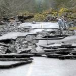 Keith Thorpe/Peninsula Daily News
Vaughan Lester of Port Angeles picks his way through the rubble of Olympic Hot Springs Road at the site of a washout in the Elwha River Valley of Olympic National Park on Thursday.
