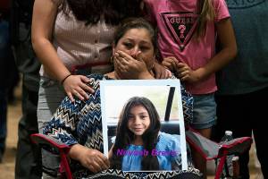 Esmeralda Bravo, 63, sheds tears while holding a photo of her granddaughter, Nevaeh, one of the Robb Elementary School shooting victims, during a prayer vigil in Uvalde, Texas, Wednesday, May 25, 2022. (AP Photo/Jae C. Hong)