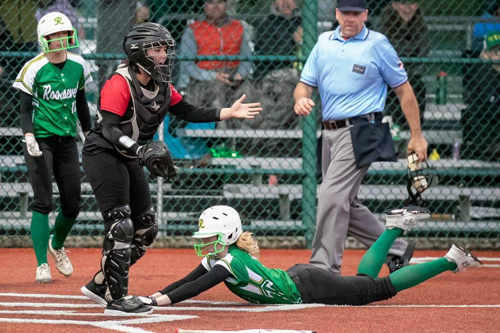 Snohomishs Alli Wilson looks for the throw with Roosevelts Sammie Wright sliding safely home in the 3A quarter-finals Friday evening in Lacey, Washington on May 27, 2022. The Panthers lost 14-13 in 8 innings. (Kevin Clark / The Herald)