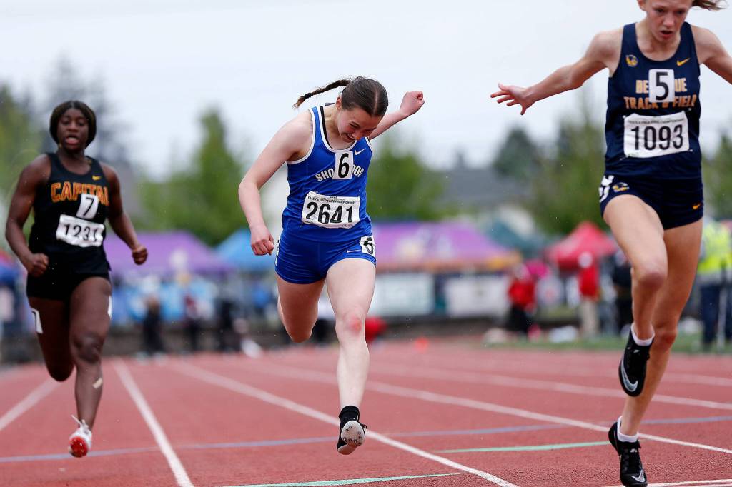 Shorewoods Gilana Wollman leans over the finish line in the 3A girls 100 meter dash Saturday, May 28, 2022, at the 2022 WIAA State Track & Field Championships at Mount Tahoma High School in Tacoma, Washington. (Ryan Berry / The Herald)