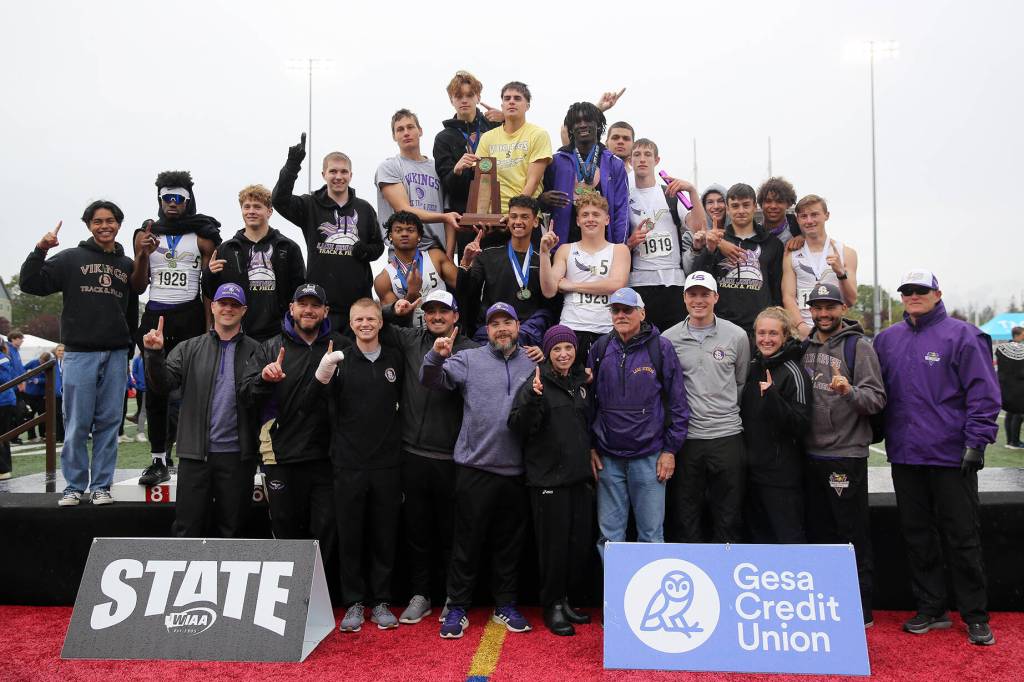 The 4A champion Lake Stevens boys track & field team stand at the podium after receiving their trophy Saturday, May 28, 2022, at the 2022 WIAA State Track & Field Championships at Mount Tahoma High School in Tacoma, Washington. (Ryan Berry / The Herald)