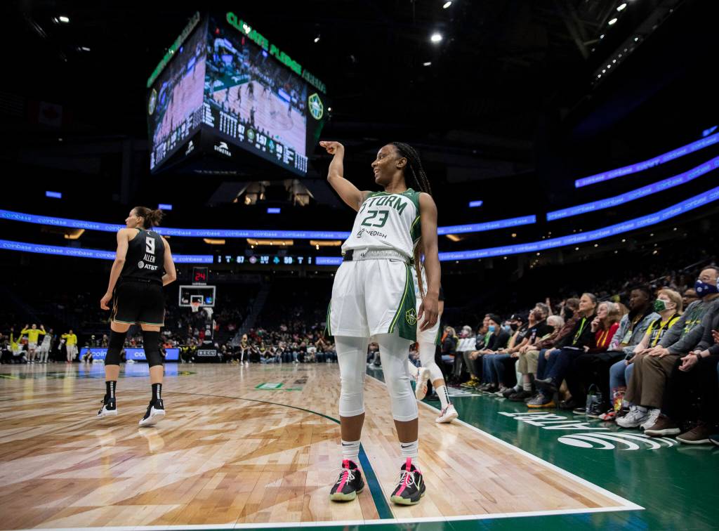Seattle Storms Kiana Williams leans backwards and crosses her fingers after making a three-point shot during the game against the Liberty on Sunday, May 29, 2022 in Seattle, Washington. (Olivia Vanni / The Herald)