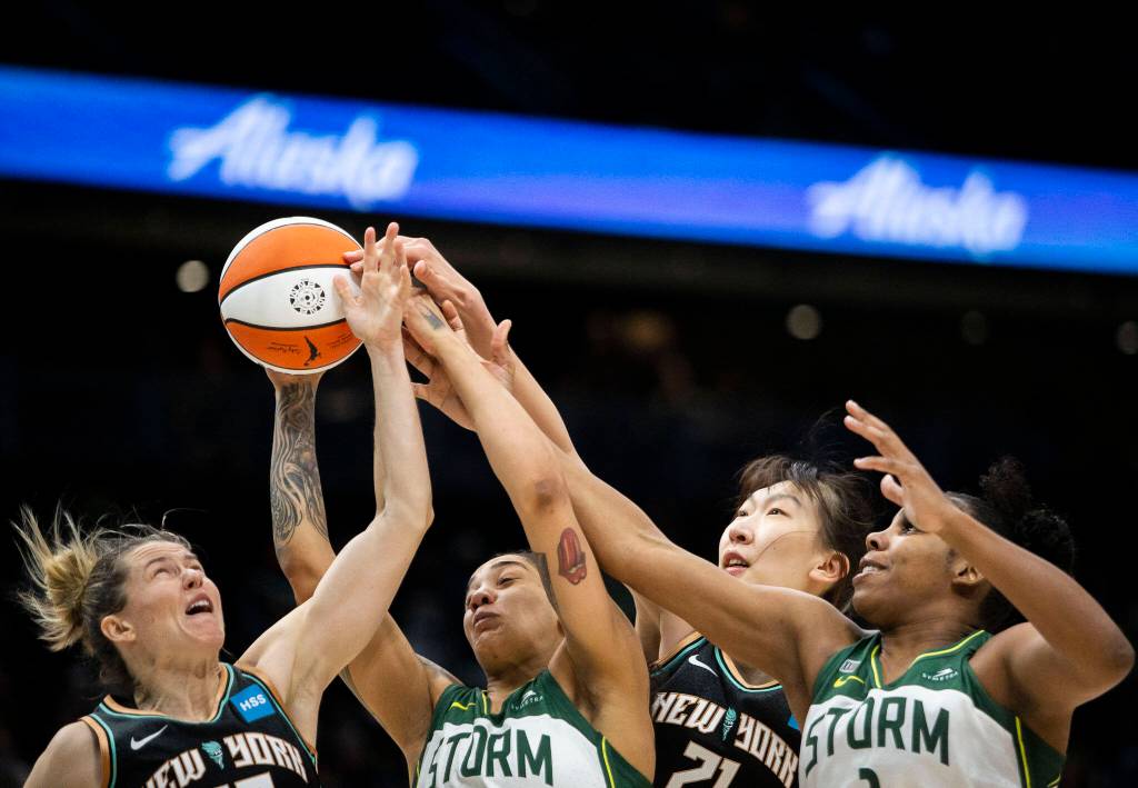 Seattle Storm and New York Liberty players all reach for a rebound during the game on Sunday, May 29, 2022 in Seattle, Washington. (Olivia Vanni / The Herald)