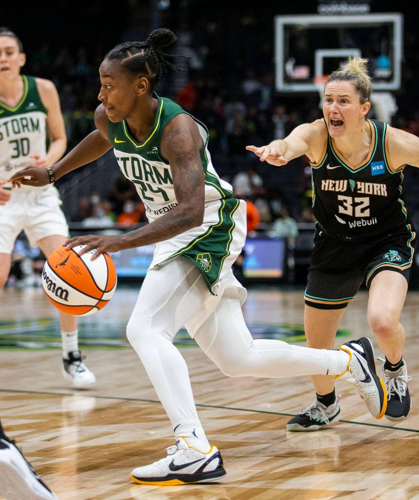Seattle Storms Jewell Loyd spins past New York Libertys Sami Whitcomb and drives to the hoop during the game on Sunday, May 29, 2022 in Seattle, Washington. (Olivia Vanni / The Herald)