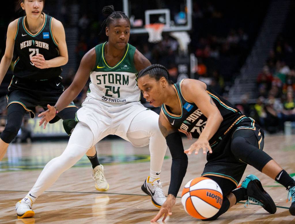 Seattle Storms Jewell Loyd trips up New York Libertys Asia (AD) Durr during the game on Sunday, May 29, 2022 in Seattle, Washington. (Olivia Vanni / The Herald)