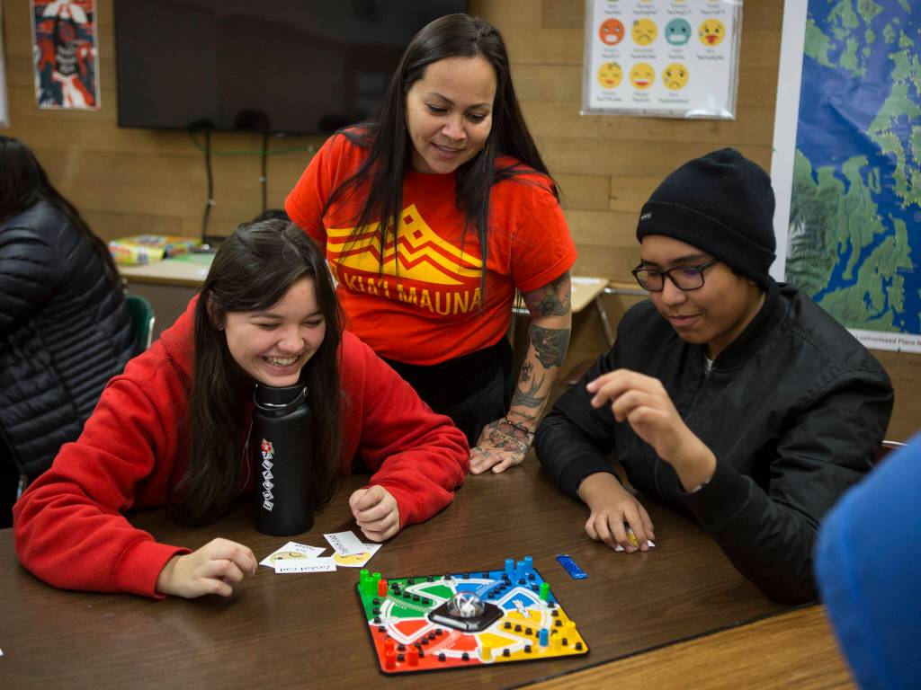 Natosha Gobin, center, watches as her students Angel Cortez, left, and Randy Vendiola, right, play a word matching game during Lushootseed I class at Marysville Pilchuck High School on Nov. 1, 2019 in Marysville. (Olivia Vanni / The Herald)