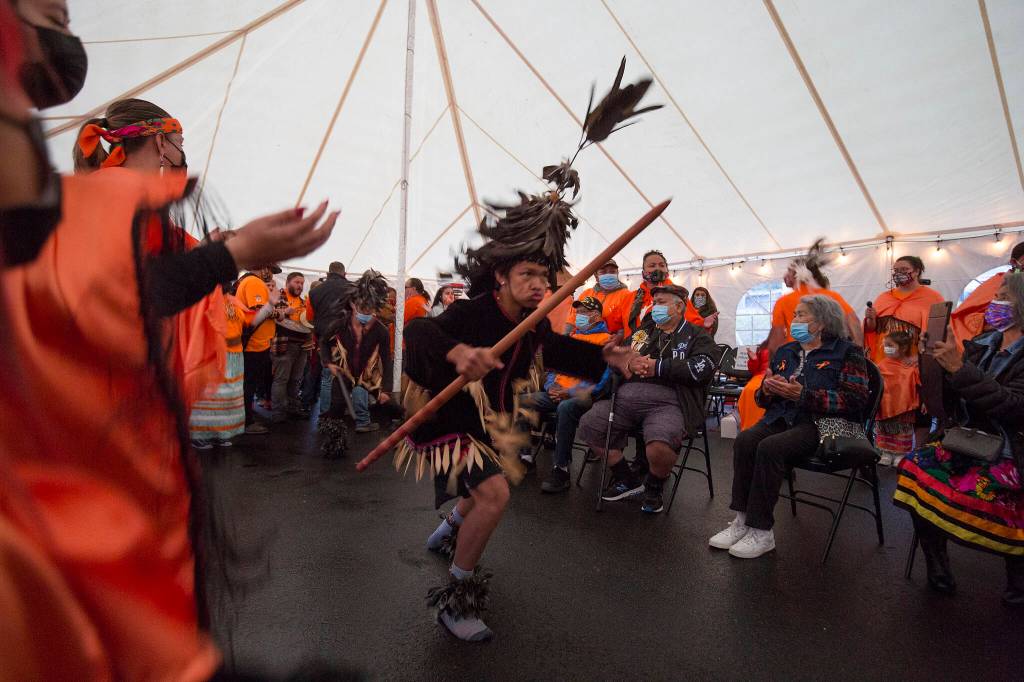 At the last remaining building from the Tulalip Indian School, dancers perform the Snohomish War Song for a Day of Remembrance on Sept. 30, 2021, on the Tulalip Reservation. (Andy Bronson / The Herald)