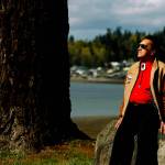 Stan Jones Sr. scans Tulalip Bay from the grounds outside the old tribal center and longhouse in April 2010. (Dan Bates / Herald file)
