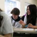 Alexa Marcelo (right), 14, and Garett Verellen, 16, paint rocks during Leadership Launchs Emotion Commotion event. (Ryan Berry / The Herald)