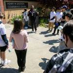 Teenagers gather around Azrael Howell before heading out on a silent, meditative walk during Leadership Launchs Emotion Commotion event. (Ryan Berry / The Herald)
