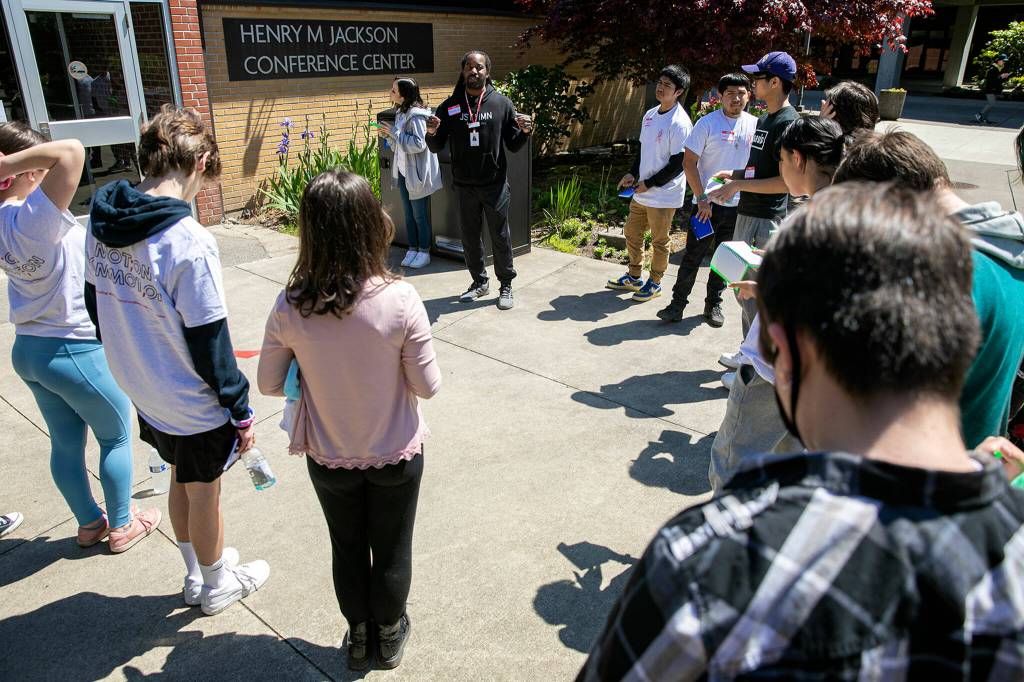 Teenagers gather around Azrael Howell before heading out on a silent, meditative walk during Leadership Launchs Emotion Commotion event. (Ryan Berry / The Herald)
