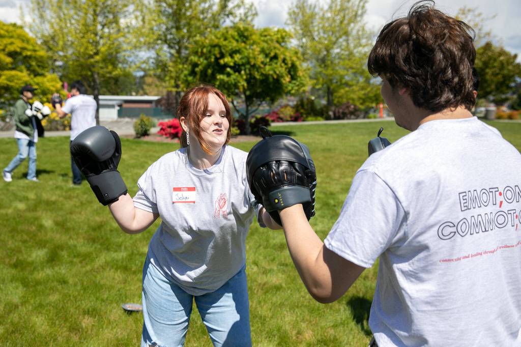 Jeslyn Kelso, 16, spars with Alberto Garcia, 17, during a martial arts session at Leadership Launchs Emotion Commotion event. (Ryan Berry / The Herald)