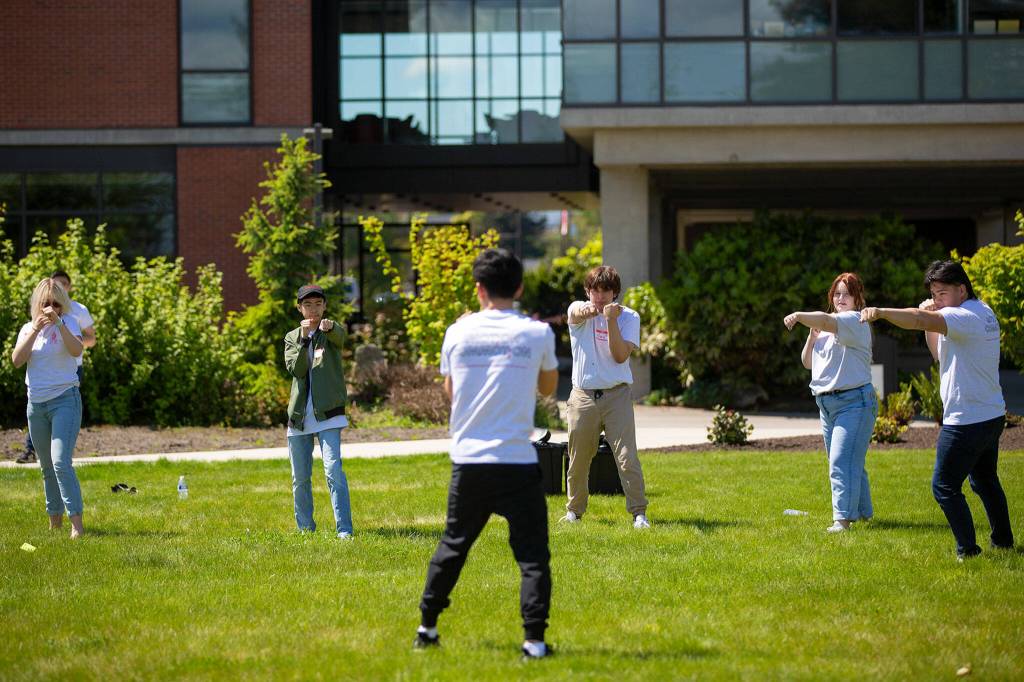 Kevin Leung leads a group of students through the basics of martial arts during Leadership Launchs Emotion Commotion event at Everett Community College in Everett. (Ryan Berry / The Herald)