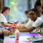 Glenda Wabaluku, 17, works together with a group of peers to piece together a creative action plan for their communities during Leadership Launch’s "Emotion Commotion" event on Saturday, May 21, 2022, at Everett Community College in Everett, Washington. (Ryan Berry / The Herald)