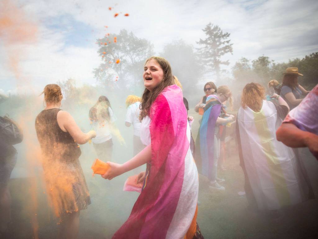 Mia Roue, 14, participates in a color throw at Stanwood and Camanos first-ever Pride celebration Saturday at Freedom Park. (Olivia Vanni / The Herald)