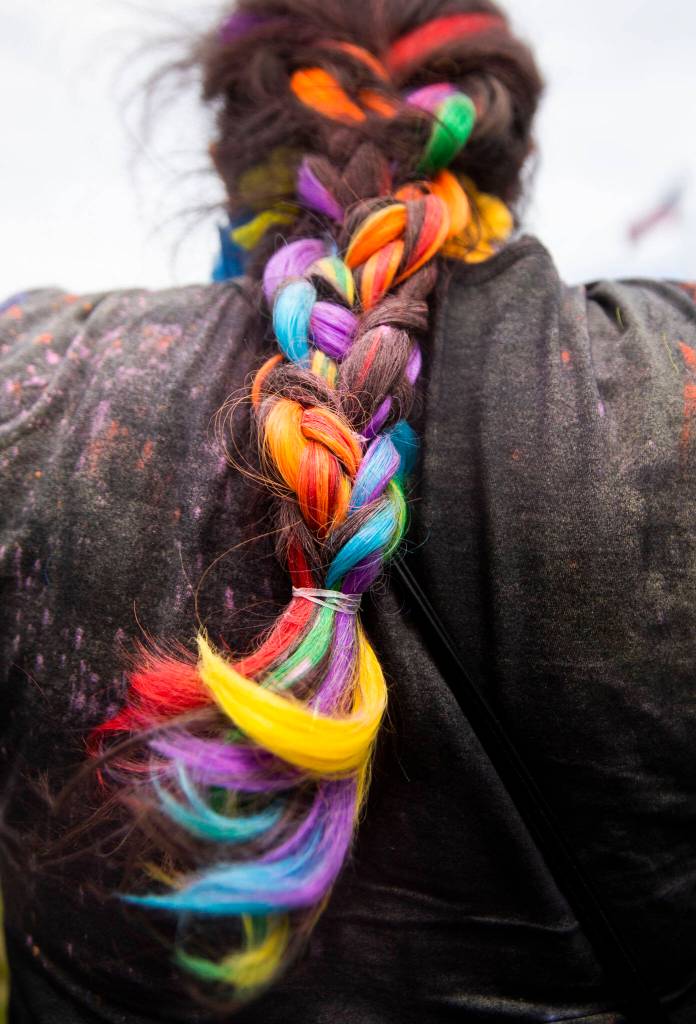 A womans rainbow braid is covered in colored powder after a color throw at Stanwood and Camanos first-ever Pride celebration Saturday at Freedom Park. (Olivia Vanni / The Herald)