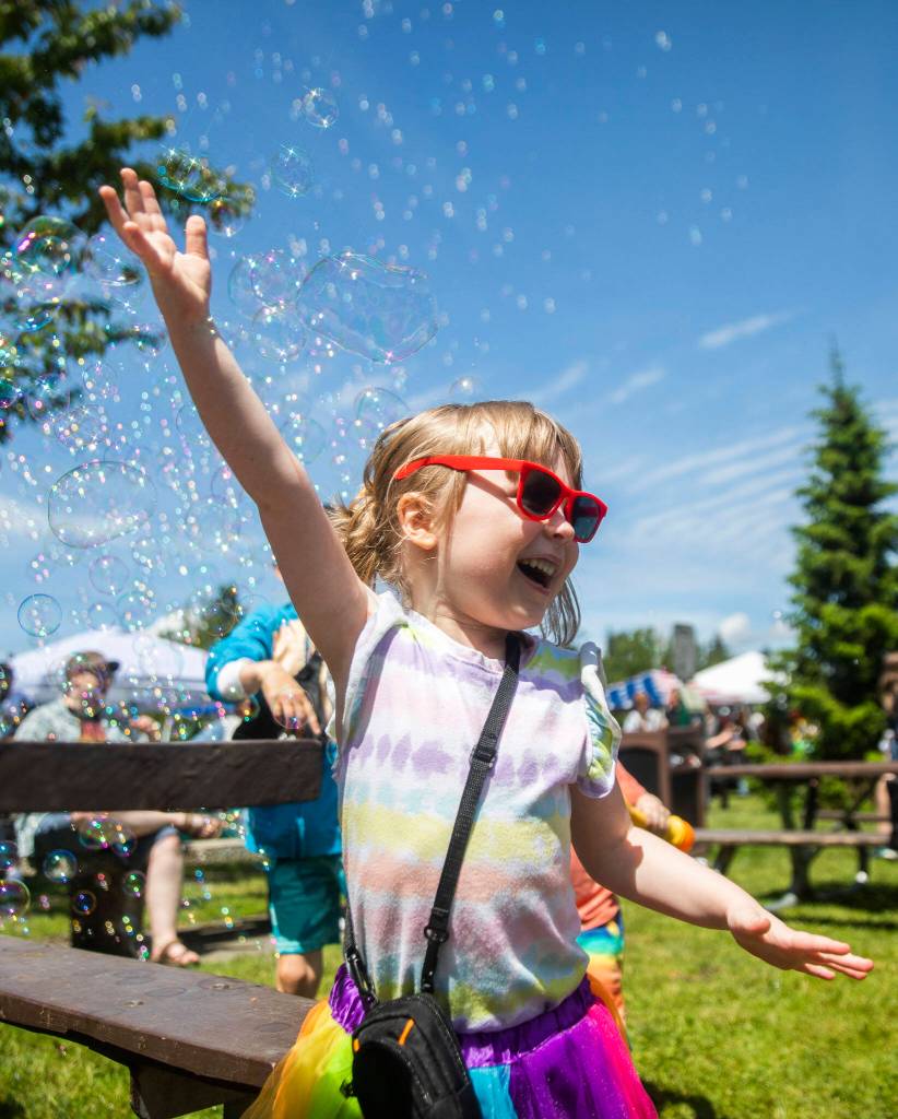 Kaydence Miller, 4, laughs while playing in bubbles at Arlingtons first-ever Pride celebration Saturday at Legion Memorial Park. (Olivia Vanni / The Herald)