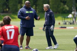 Seattle Seahawks defensive coordinator Clint Hurtt, left, talks with head coach Pete Carroll during NFL football practice Monday, May 23, 2022, in Renton, Wash. (AP Photo/Ted S. Warren)