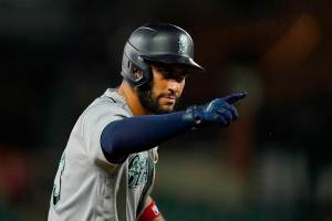 Seattle Mariners' Abraham Toro gestures toward his dugout after bringing in Eugenio Suarez with a run on an RBI triple against the Baltimore Orioles during the 10th inning of a baseball game, Thursday, June 2, 2022, in Baltimore. The Mariners won 7-6 in ten innings. (AP Photo/Julio Cortez)