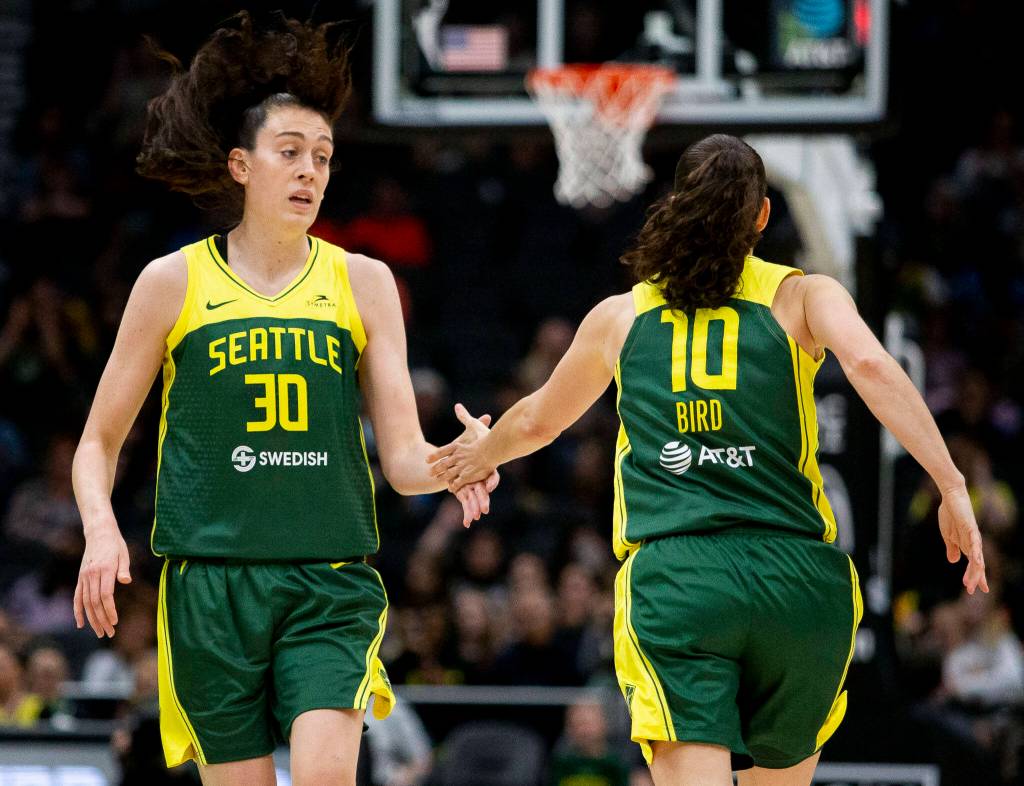 Seattle Storms Breanna Stewart high fives Sue Bird after making a three-point shot during the game against the Connecticut Sun on Sunday, June 5, 2022 in Seattle, Washington. (Olivia Vanni / The Herald)