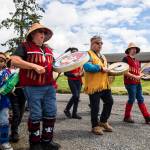 Tulalip Tribes drummers and singers make their way down to the water to greet the King Salmon as it is carried back to the longhouse during Salmon Ceremony on Saturday in Tulalip. (Olivia Vanni / The Herald)