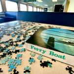 A puzzle is back on a ferry table on the Mukilteo-Clinton route. Community jigsaw puzzles, a passenger pastime on most routes, were removed during COVID. (Andrea Brown / The Herald)