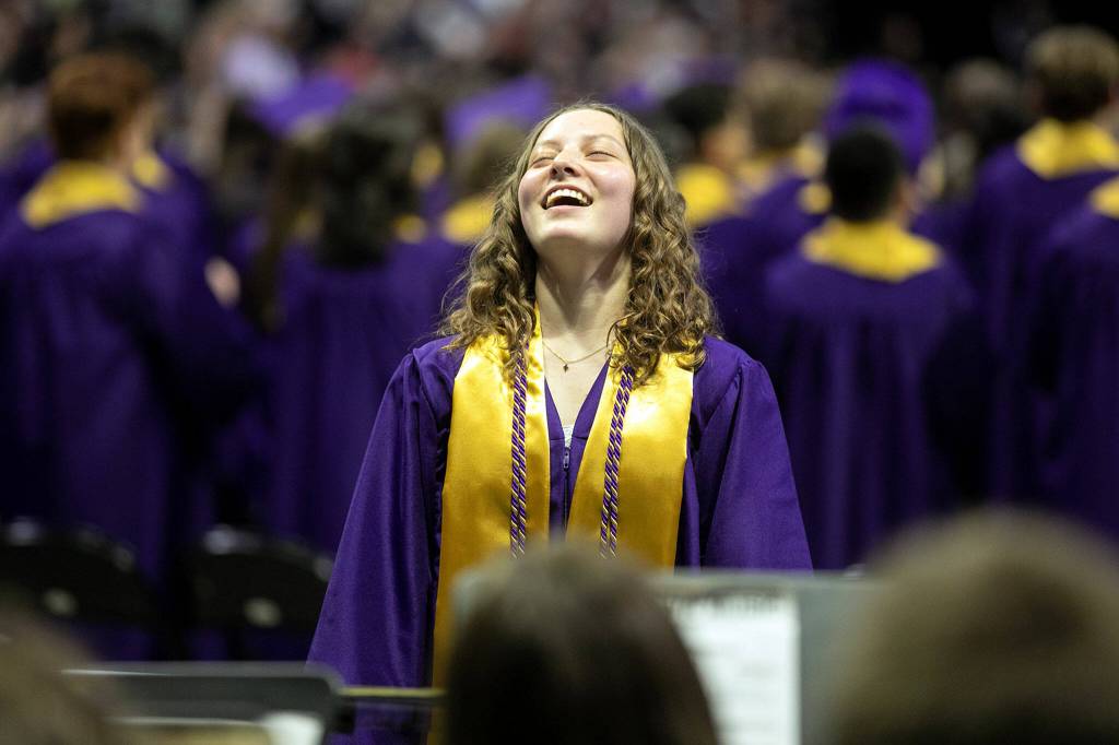 Graduating drum major Holly Balan exhales after completing the Star Spangled Banner with her band for the last time during Lake Stevens High Schools 2022 commencement ceremony Tuesday at Angel of the Winds Arena in Everett. (Ryan Berry / The Herald)