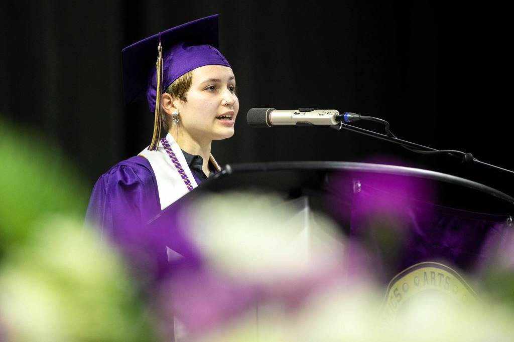 Kaitlyn Johnson, who was chosen by classmates to deliver a speech at graduation, addresses a crowd of thousands during Lake Stevens High Schools 2022 commencement ceremony Tuesday at Angel of the Winds Arena in Everett. (Ryan Berry / The Herald)