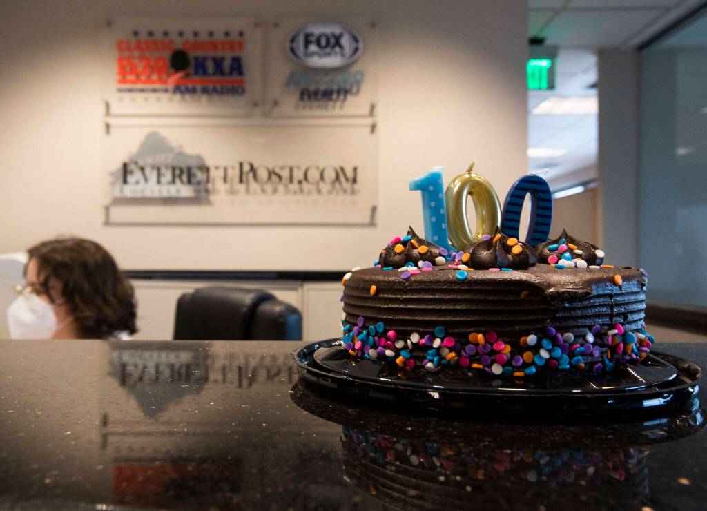 A birthday cake celebrating KRKOs 100 year birthday sits on the reception counter on Thursday in Everett. (Olivia Vanni / The Herald)