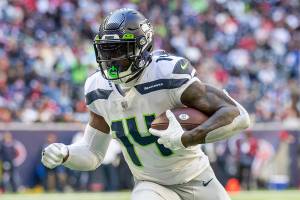 Wide receiver (14) DK Metcalf of the Seattle Seahawks catches a pass and runs against the Houston Texans in an NFL football game, Sunday, Dec. 12, 2021, in Houston, TX. Seahawks defeated the Texans 33-13. (AP Photo/Jeff Lewis)